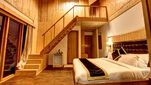 A wooden interior with a bed, a staircase, and a door. - Hill County Resort & Spa, Manali (Manali)