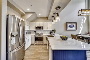 Prepare meals in this well-lit kitchen with an oven and ample counter space.