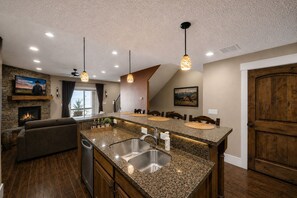 A kitchen with granite countertops, a built-in sink, and pendant lighting. - Park's Edge 844 (Kamas)