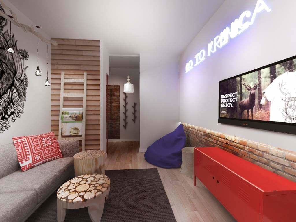 Un salon moderne avec un canapé, un meuble rouge, un téléviseur et un panneau mural.