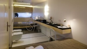 A compact, modern bathroom with a toilet, sink, and shower area. - Liv Inn Guest House (Maputo)