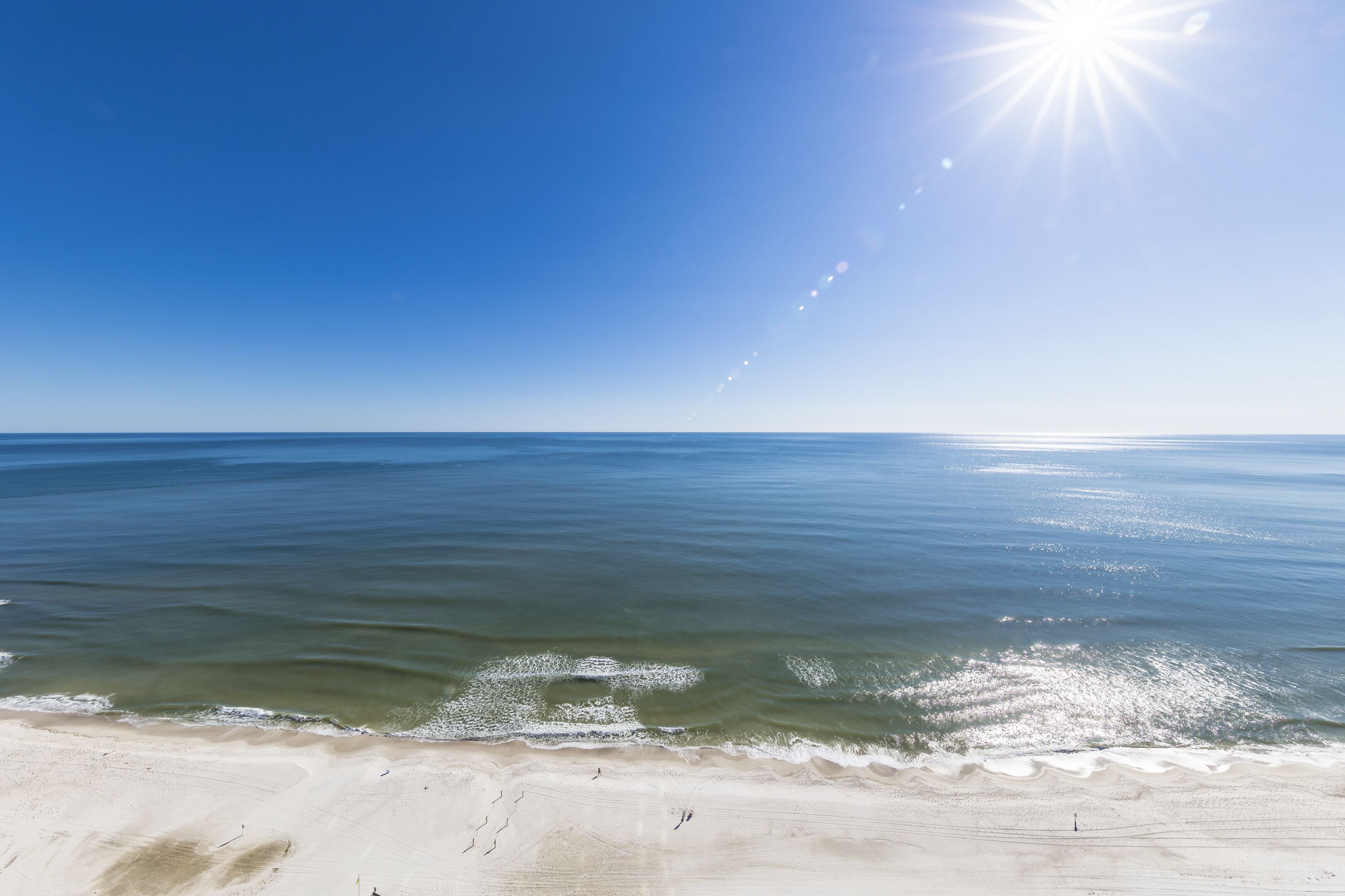 A beach with clear skies and calm waters.