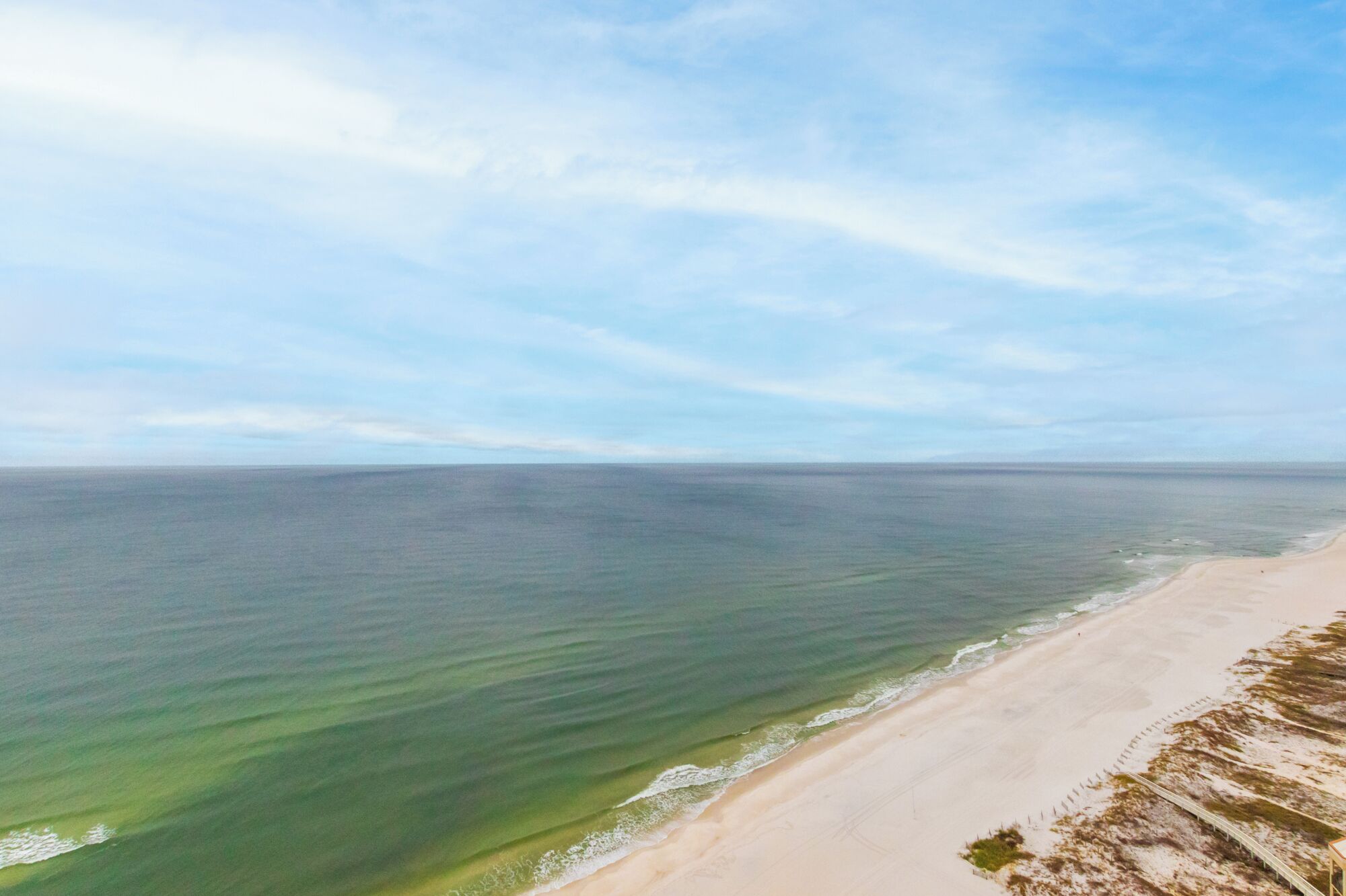 A beach with clear water and a sandy shore.