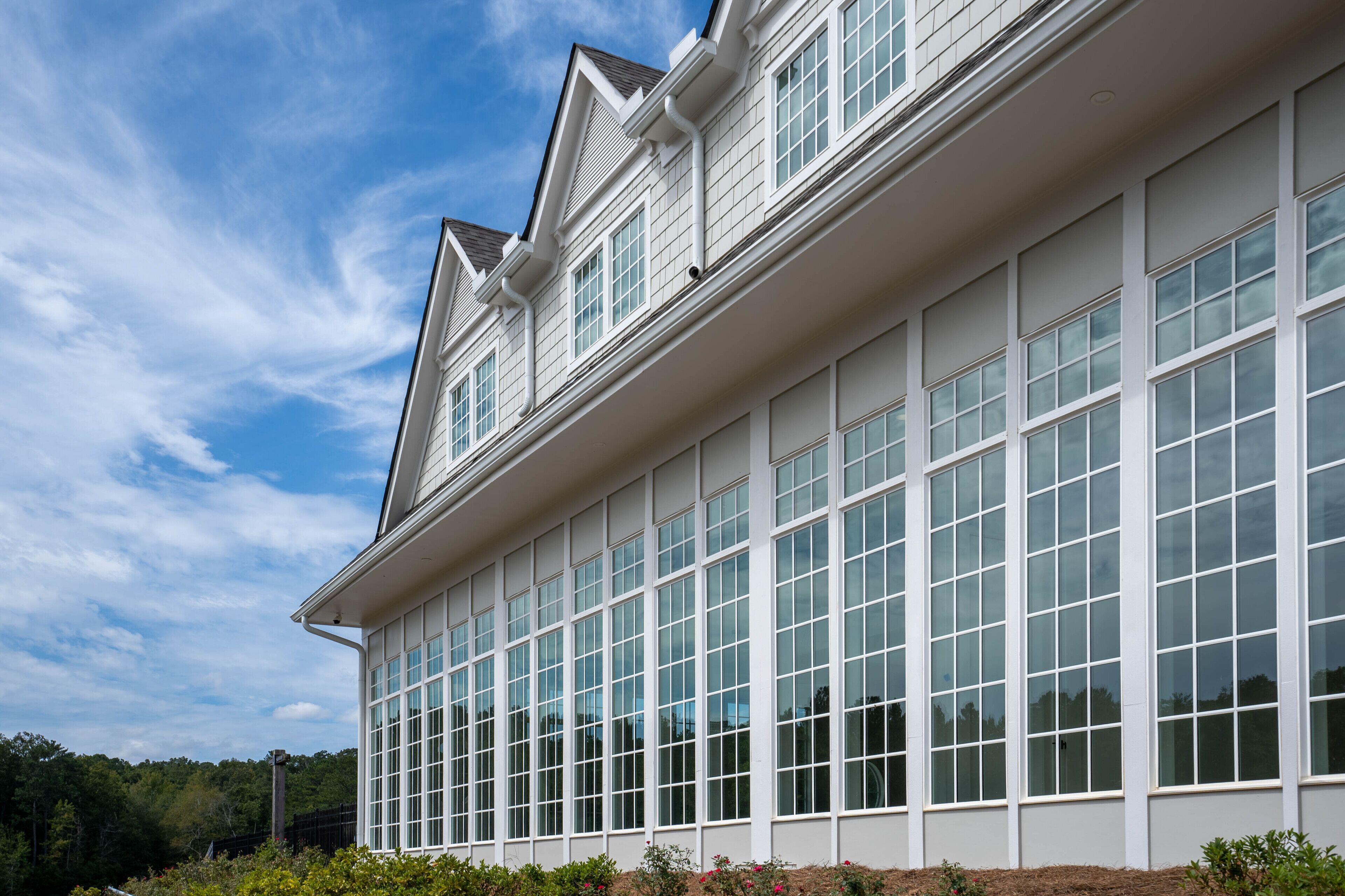 A large, modern building with multiple windows and a symmetrical facade.