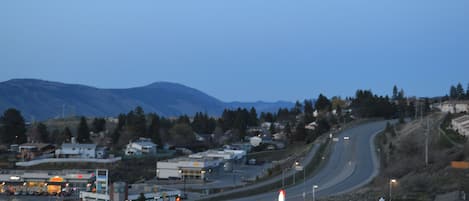 A highway interchange with multiple lanes and a gas station on the right.