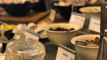 A buffet with various food items and a sign labeled "DATES".