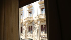 A building facade with ornate architectural details, including balconies and arched windows. - Dimi House (Lecce)