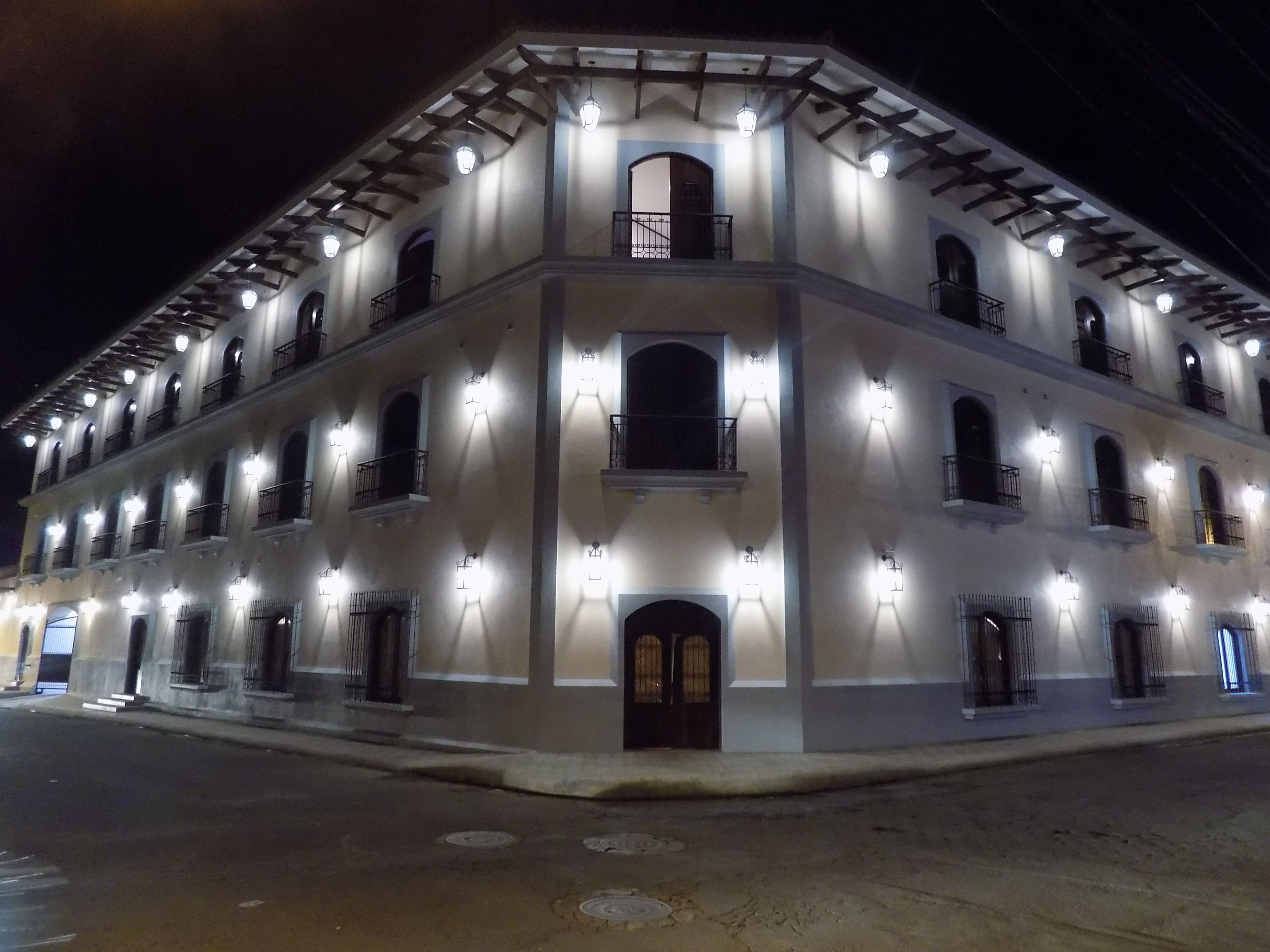 A multi-story building with a symmetrical facade, evenly spaced windows, and a central entrance.