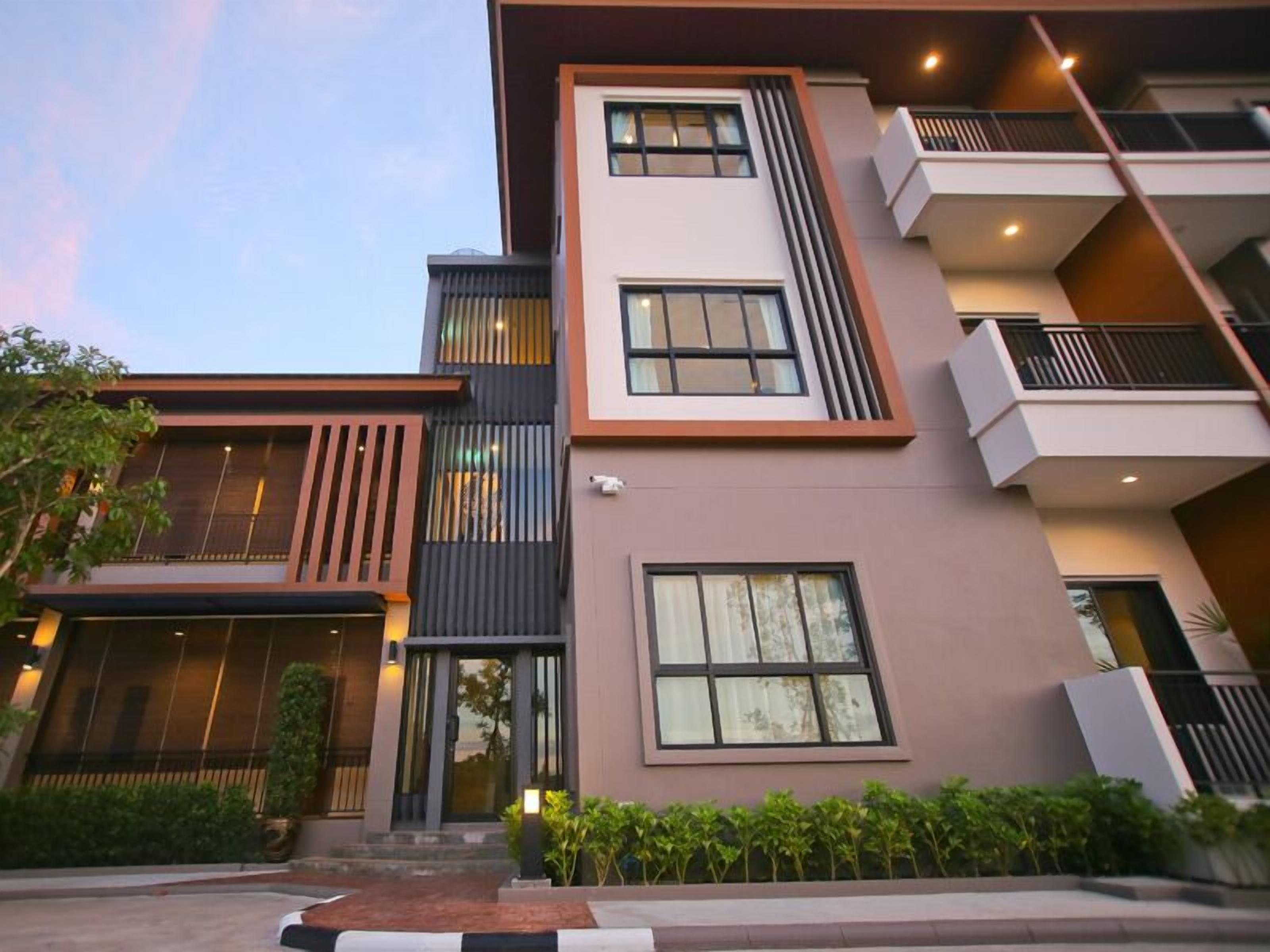 A multi-story hotel with a modern design, featuring balconies, large windows, and a well-maintained exterior.