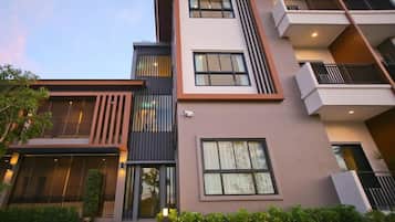 A multi-story hotel with a modern design, featuring balconies, large windows, and a well-maintained exterior.
