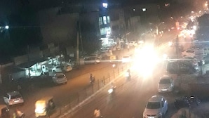 A nighttime street scene with vehicles and motorcycles. - Rajdhani guest house (Faridabad)