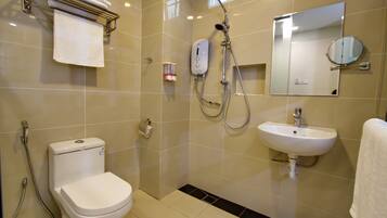 A modern bathroom with a toilet, sink, and shower.