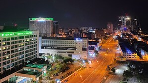 A cityscape at night with a medical center and a hotel. - Amadel Residence (Malacca City)