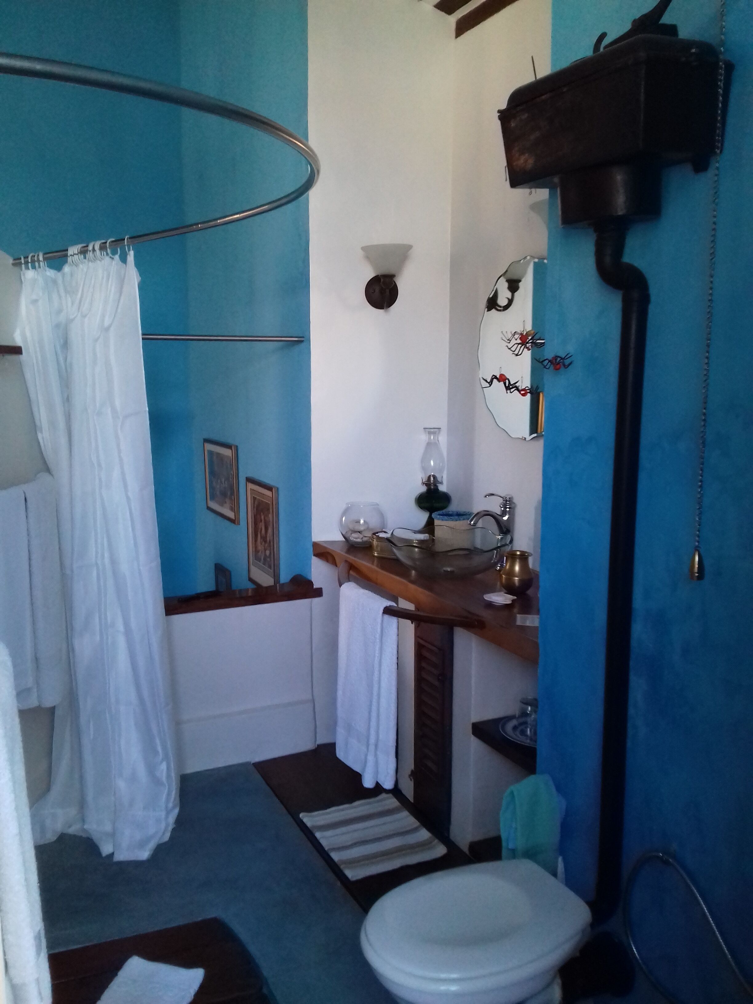 A bathroom with a shower, sink, and toilet.