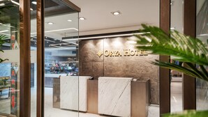A reception desk with a marble top and a sign that reads "ORYA HOTEL". - Orya Hotel (Istanbul)