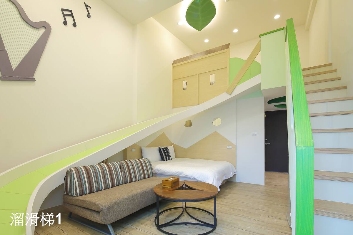 A modern interior with a curved bench, a bed, and a staircase.