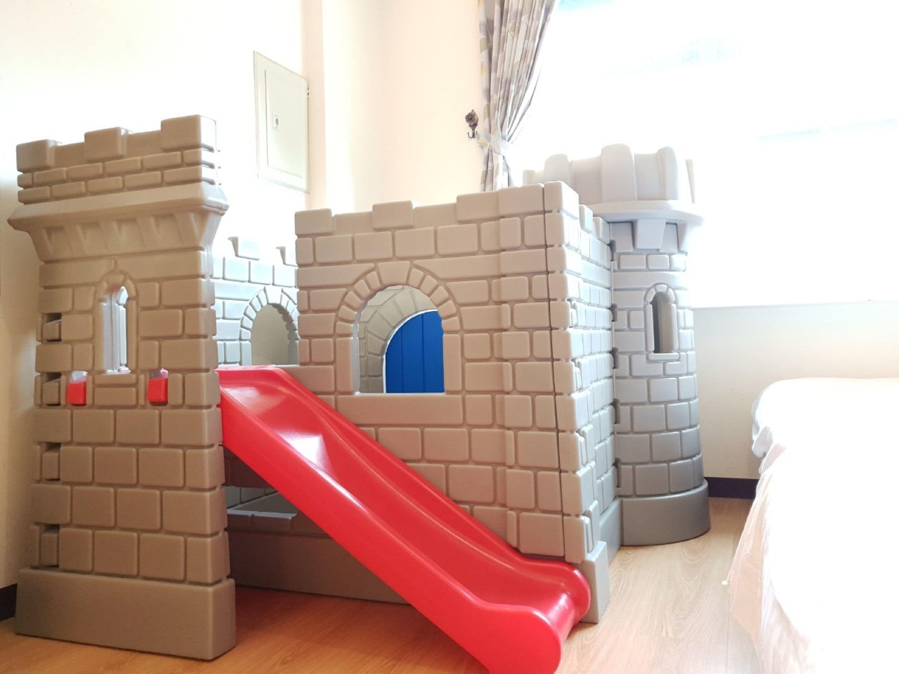 A children's play area with a slide and castle-like structures.