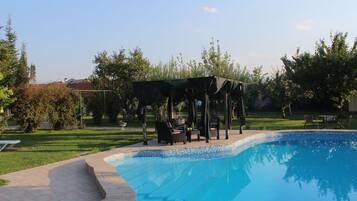 Seasonal outdoor pool, pool umbrellas, pool loungers