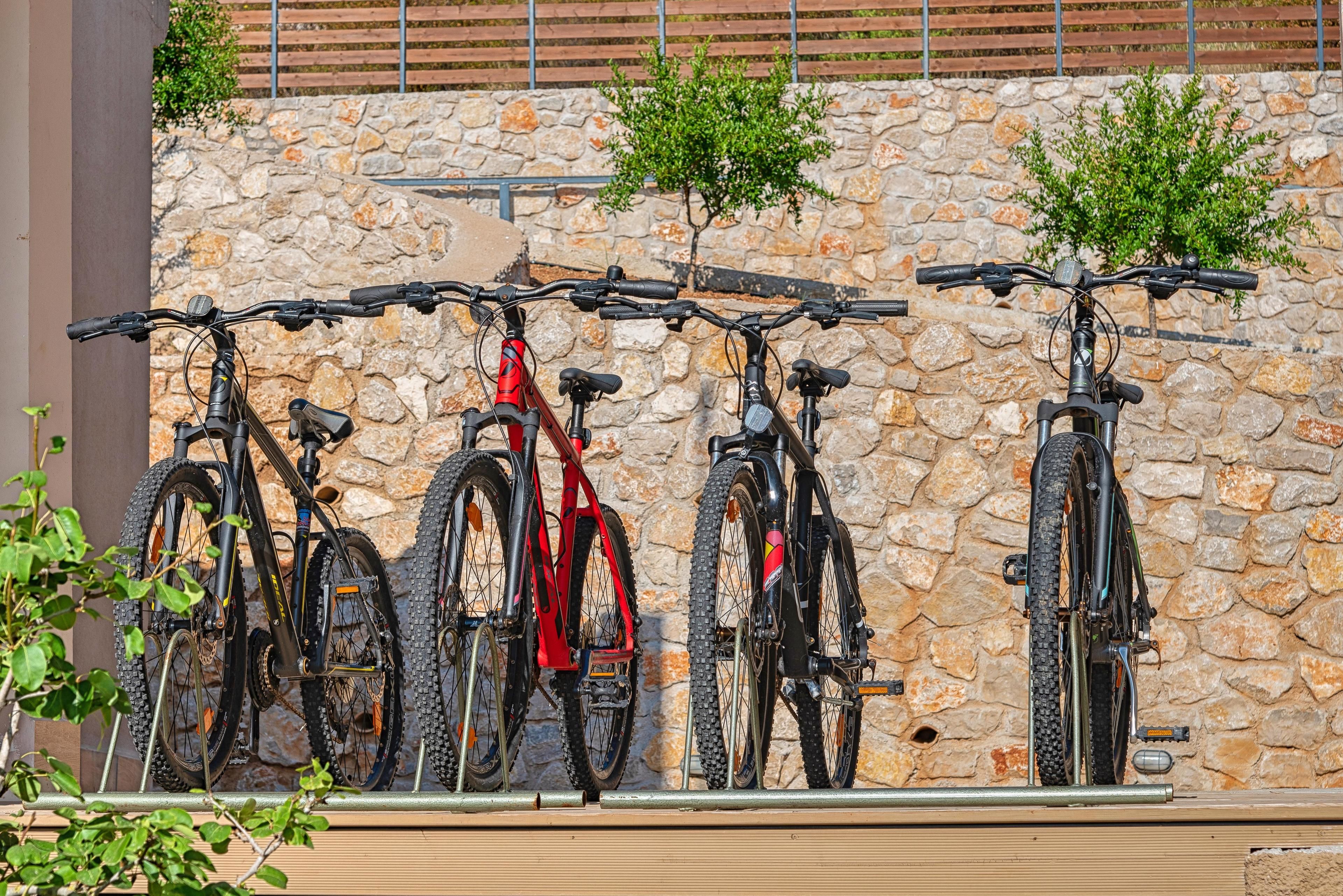 A row of bicycles mounted on a stone wall.