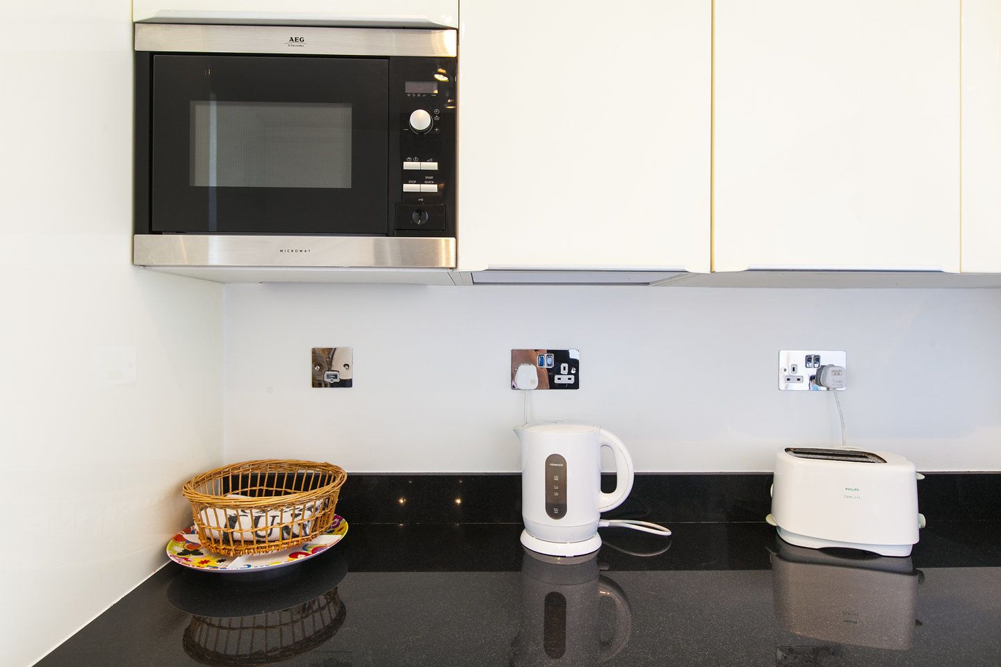 A kitchenette with a microwave, a coffee maker, and a toaster.