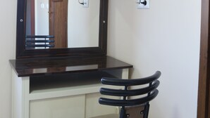 A room with a wooden desk, a chair, a mirror, an air conditioner, and a flat-screen TV mounted on the wall. - Beyoglu Huzur Hotel (Istanbul)
