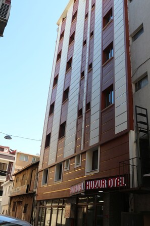A multi-story building with a sign reading "Huzur Hotel." - Beyoglu Huzur Hotel (Istanbul)