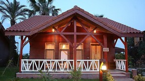 A wooden villa with a tiled roof, a porch with white railings, and a sign indicating the name "Villa 3". - Nerissa Hotel - Special Class (Kemer)