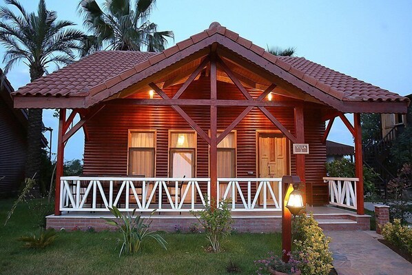 A wooden villa with a tiled roof, a porch with white railings, and a sign indicating the name "Villa 3". - Nerissa Hotel - Special Class (Kemer)