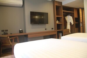 A hotel room with a bed, a desk, a chair, a TV, and a wardrobe. - Stay With Nimman Chiang Mai (Chiang Mai)