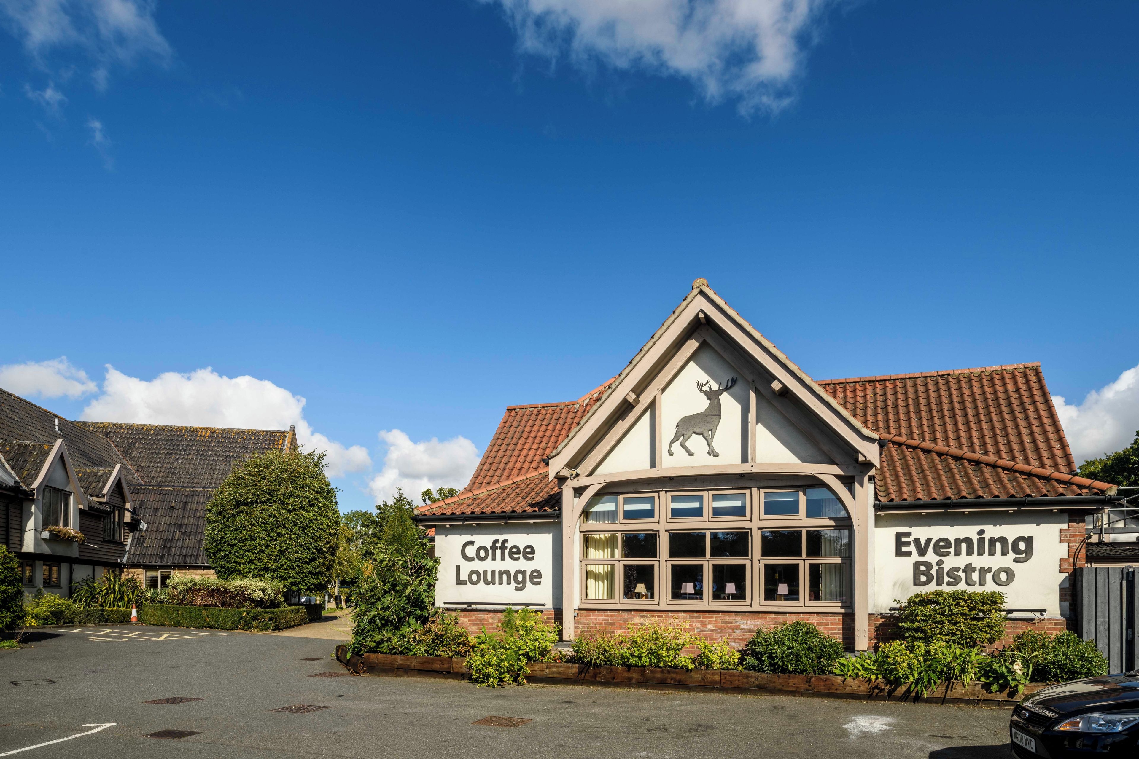 A building with a sign that reads 'Coffee Lounge' and 'Evening Bistro'.