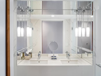 Designer toiletries, hair dryer, bathrobes, slippers at 33 Hotel, New York City, Seaport