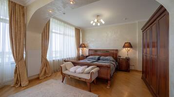 A bedroom with a wooden bed, a bench, a nightstand, and a wardrobe.