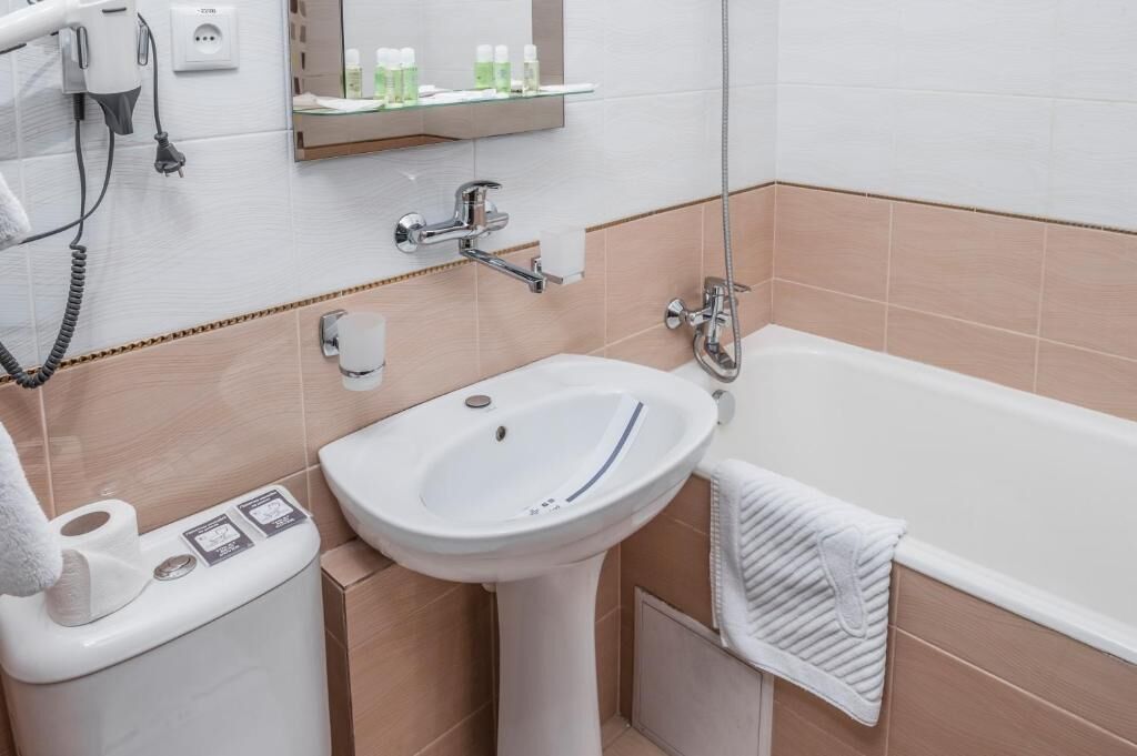 A bathroom with a sink, toilet, and bathtub.