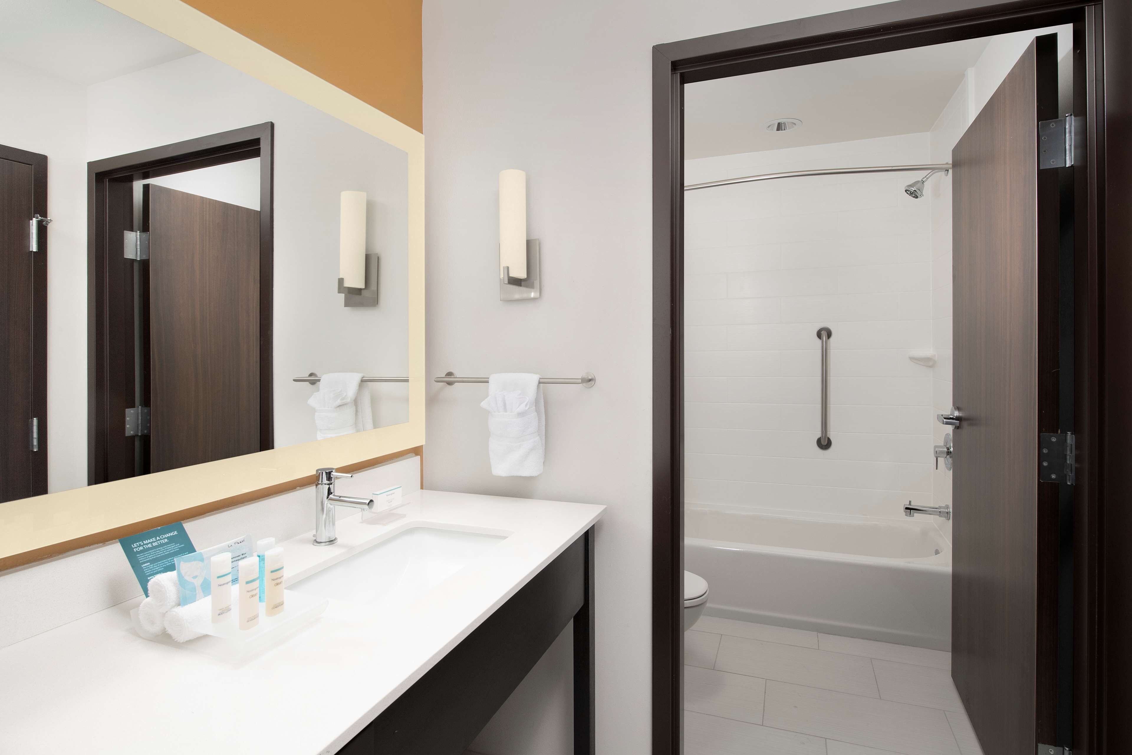 designer toiletries, hair dryer, towels