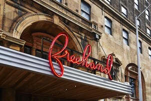 A building with a large, illuminated sign reading "Freehand."