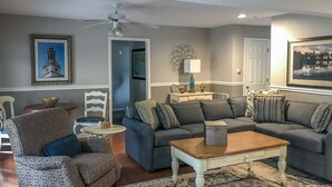 A living room with a sofa, armchair, coffee table, and a patterned rug. - Holiday Inn Club Vacations Oak 'n Spruce Resort (South Lee)