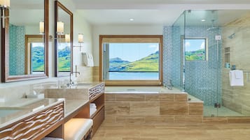 A modern bathroom with a large window, a glass shower enclosure, and a wooden vanity.