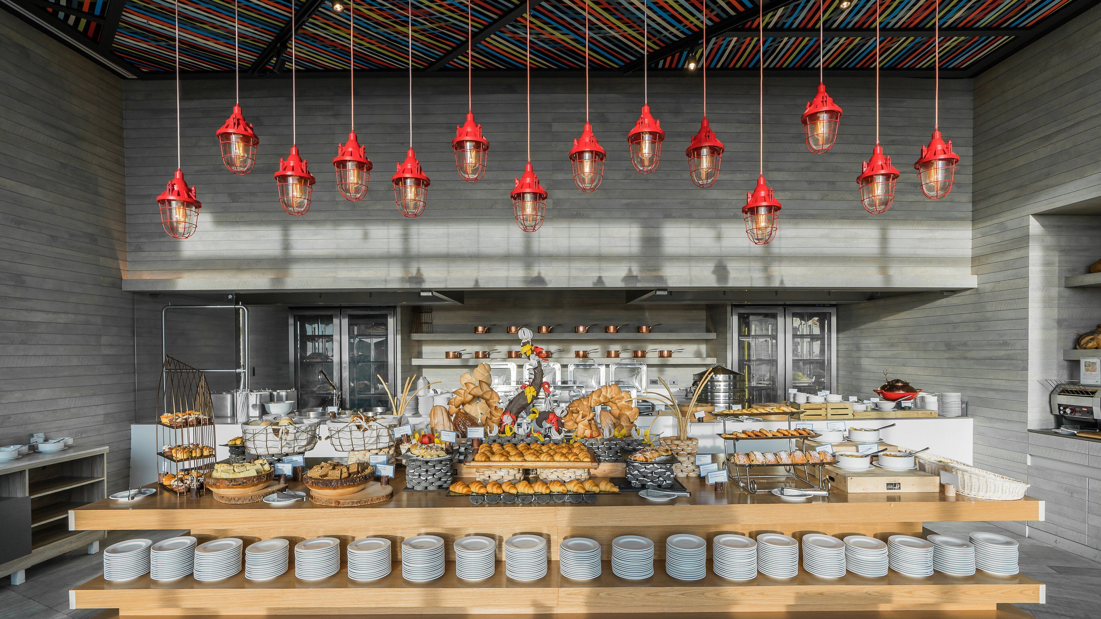 A modern kitchen with a display of baked goods and a variety of cooking utensils.