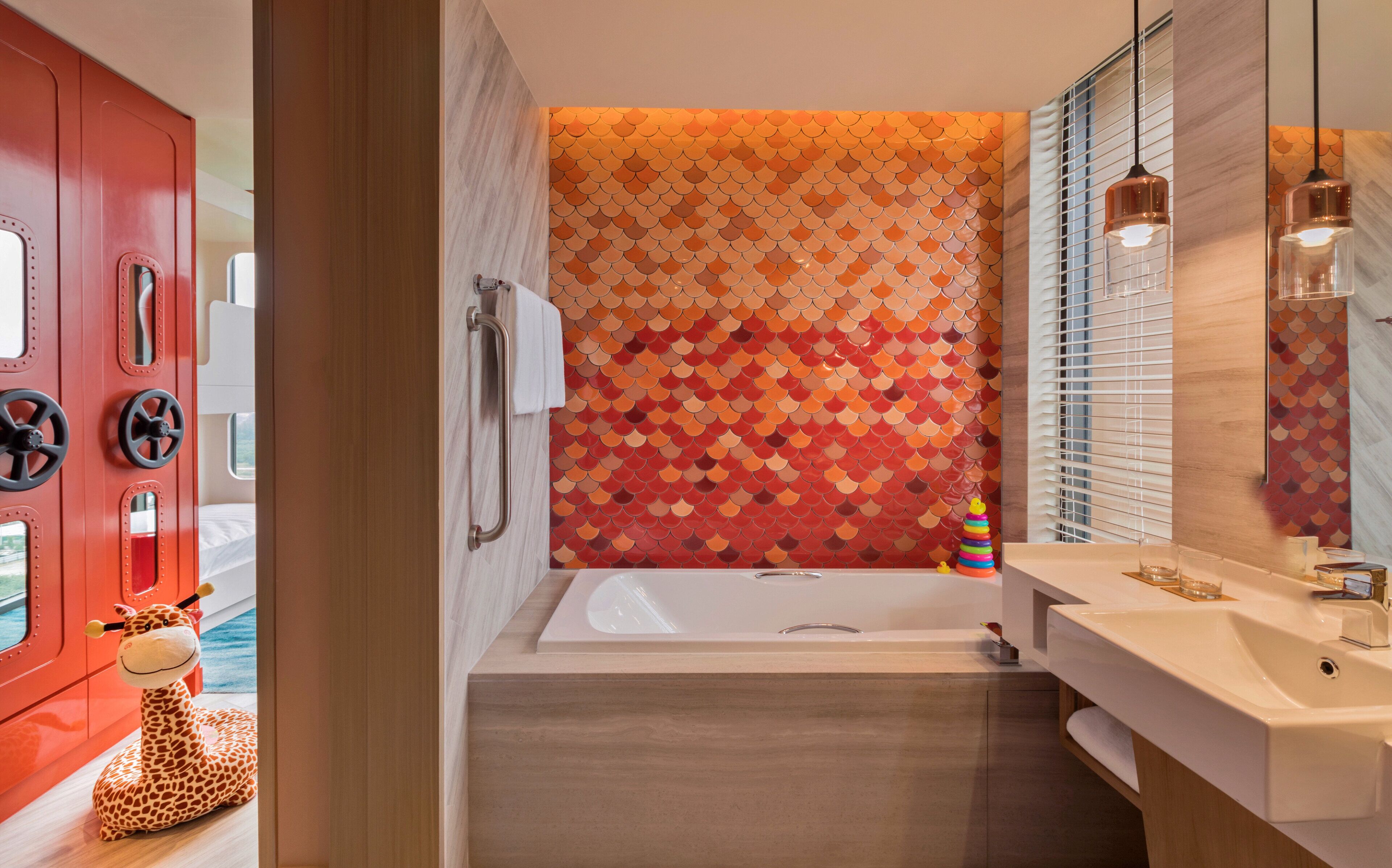 A modern bathroom with a bathtub, a sink, and a mirror.