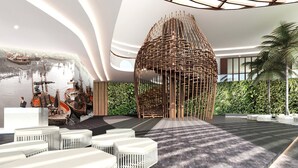 A modern lobby with a central seating area, a unique wooden structure, and a view of boats in the background. - Holiday Inn Resort Vana Nava Hua Hin by IHG (Hua Hin)