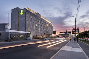 A Holiday Inn hotel with a modern design, featuring a prominent logo and a flat facade.