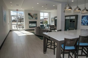 A modern interior with a large dining area, seating, and artwork on the walls.