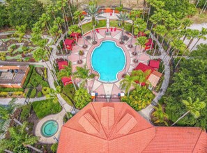 An aerial view of a resort with a central swimming pool, surrounded by palm trees and outdoor seating areas. - FREE, ✅BBQ GRILL ✅FULL BODY MASSAGE CHAIR, INCLUDED, ✅ (Davenport)