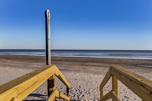 A wooden beach boardwalk leading to the ocean with a clear sky. - Historic Beach Cottage - Steps to Beach & Dining (Saint Simons Island)
