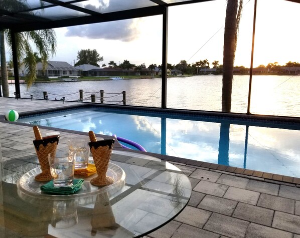 Outdoor pool, a heated pool - Lakefront Luxury Paradise: 80ft Waterfront, Private Pier & Heated Pool Oasis! (Cape Coral)