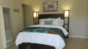 A bedroom with a bed, a wall-mounted sign, and a vent. - "Balboa Beach Escape"  Steps to Beach and Bay A/C + Garage Parking (Newport Beach)
