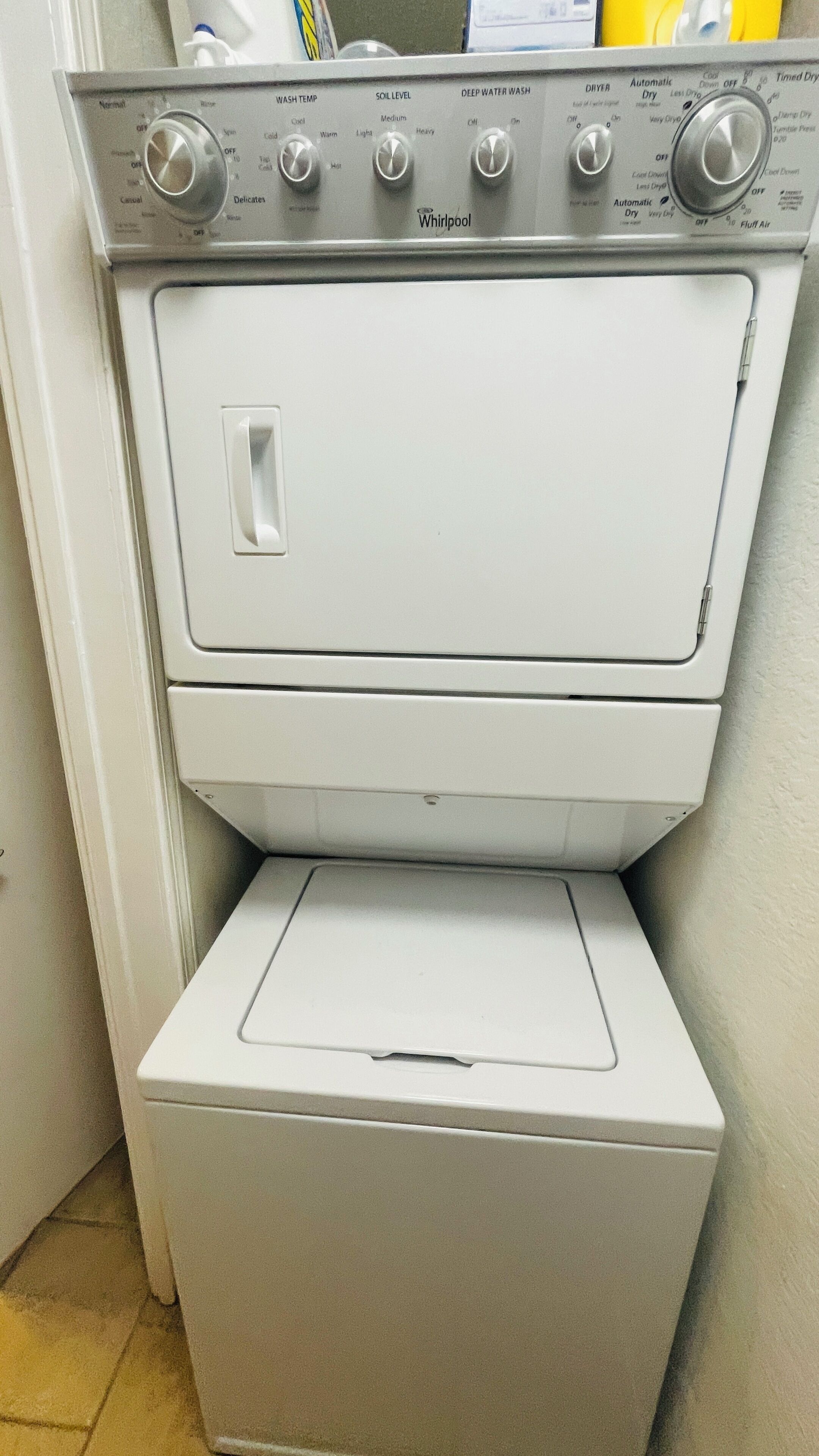 A Whirlpool washer and dryer unit with control knobs for various settings.