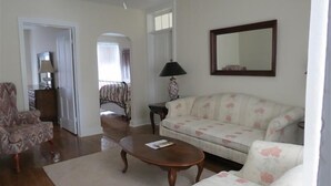 A living room with a sofa, armchair, coffee table, and a ceiling fan. - ' Experience ' The History In Downtown Gettysburg! - 2nd floor (Gettysburg)