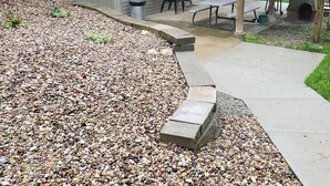 A patio area with a gravel pathway leading to a covered seating area with a table and chairs. - Sander Ridge - 40 wooded acres (Columbia)