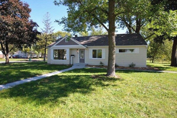 A single-story house with a front porch, a garage, and a well-maintained lawn.
